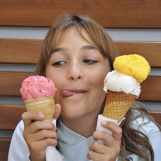 Young girl deciding which ice-cream she wants